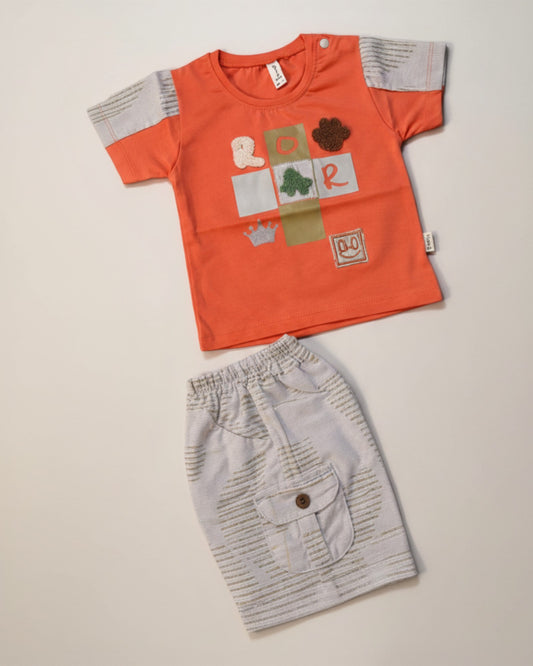Little Roots baby boy orange cotton graphic t-shirt with ROAR patch design and light grey cargo shorts with elastic waist.