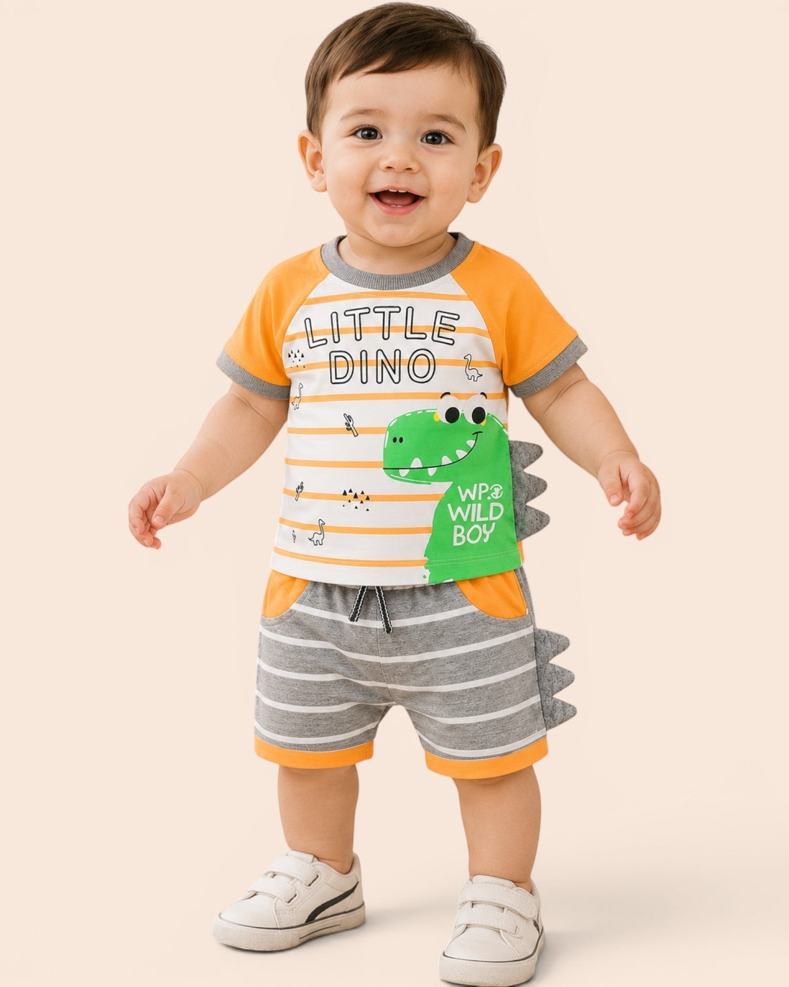 Little Roots baby boy orange and white striped dino t-shirt with grey striped shorts and 3D spikes.