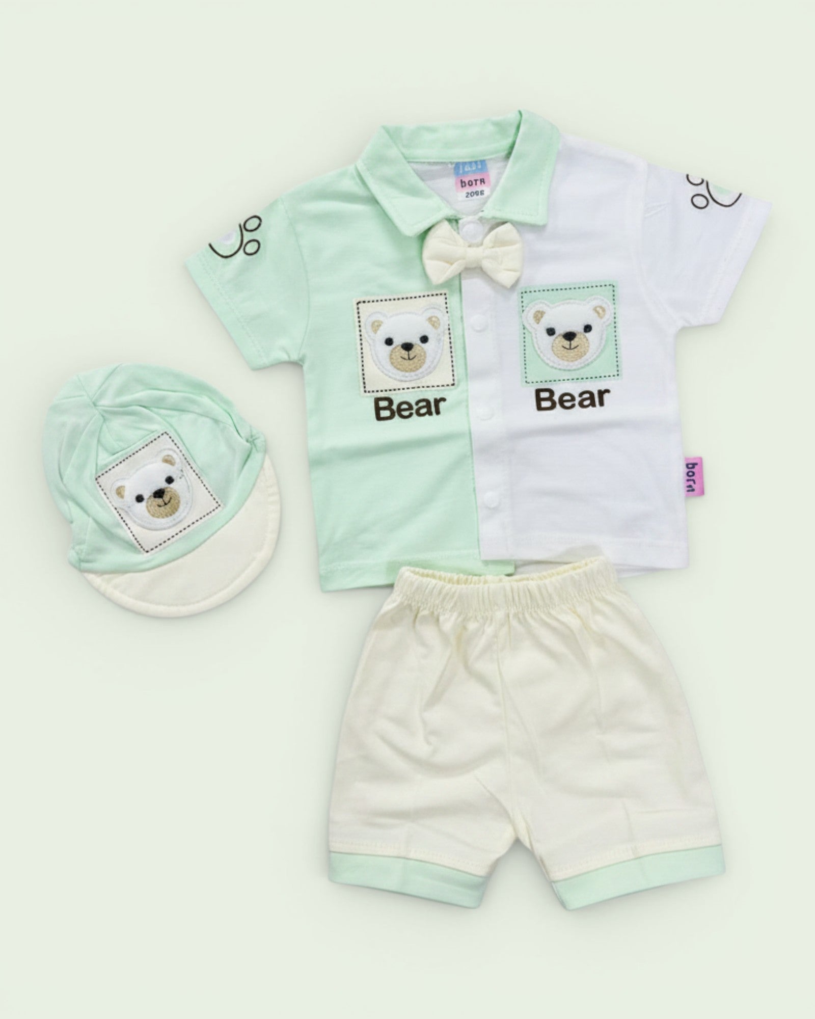 Little Roots baby boy 3-piece outfit set with mint green and white color-block shirt, bow tie, shorts, and cap featuring bear embroidery.