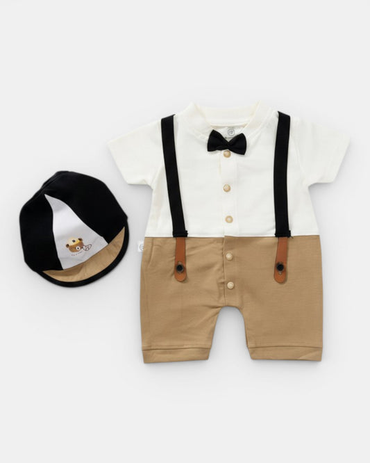 Little Roots baby boy formal romper set in white and khaki with black bow tie and suspenders, includes matching cap.
