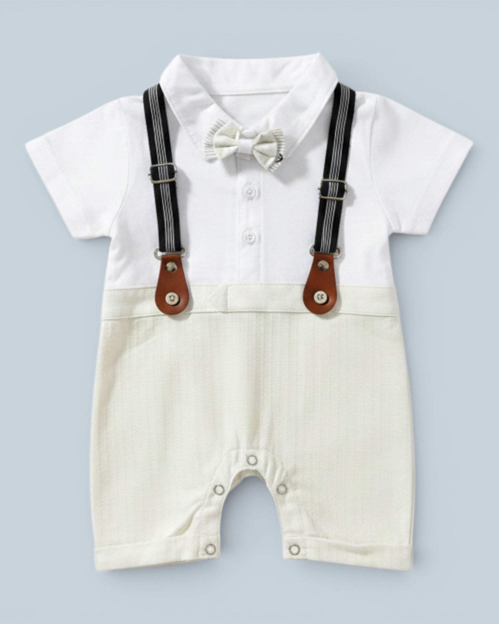 Little Roots baby boy white short-sleeve romper with cream textured shorts, black suspenders, and cream bow tie. Perfect for formal occasions.