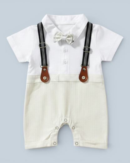 Little Roots baby boy white short-sleeve romper with cream textured shorts, black suspenders, and cream bow tie. Perfect for formal occasions.