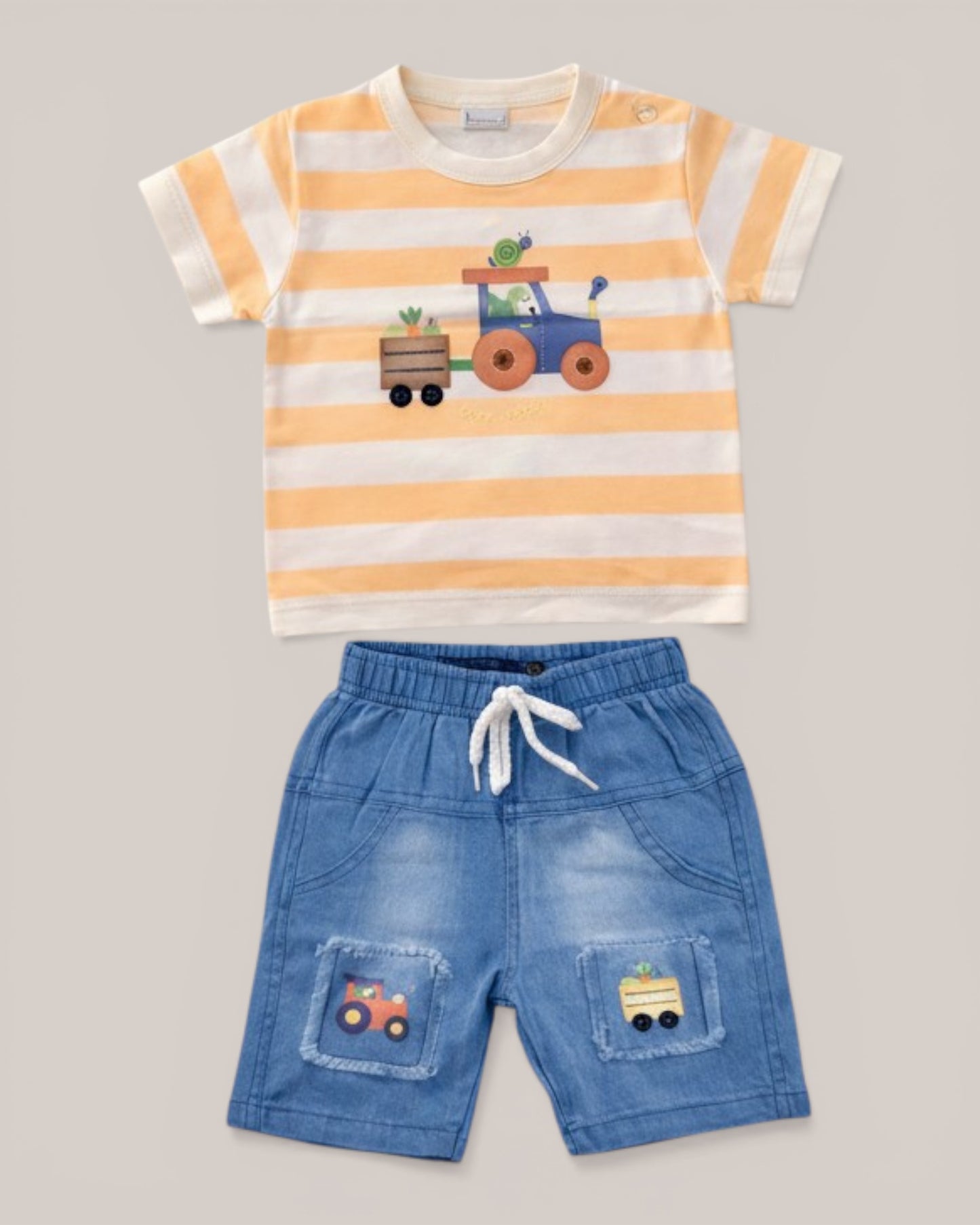 Little Roots baby boy's orange and white striped t-shirt with tractor print, paired with blue denim shorts. Summer outfit.