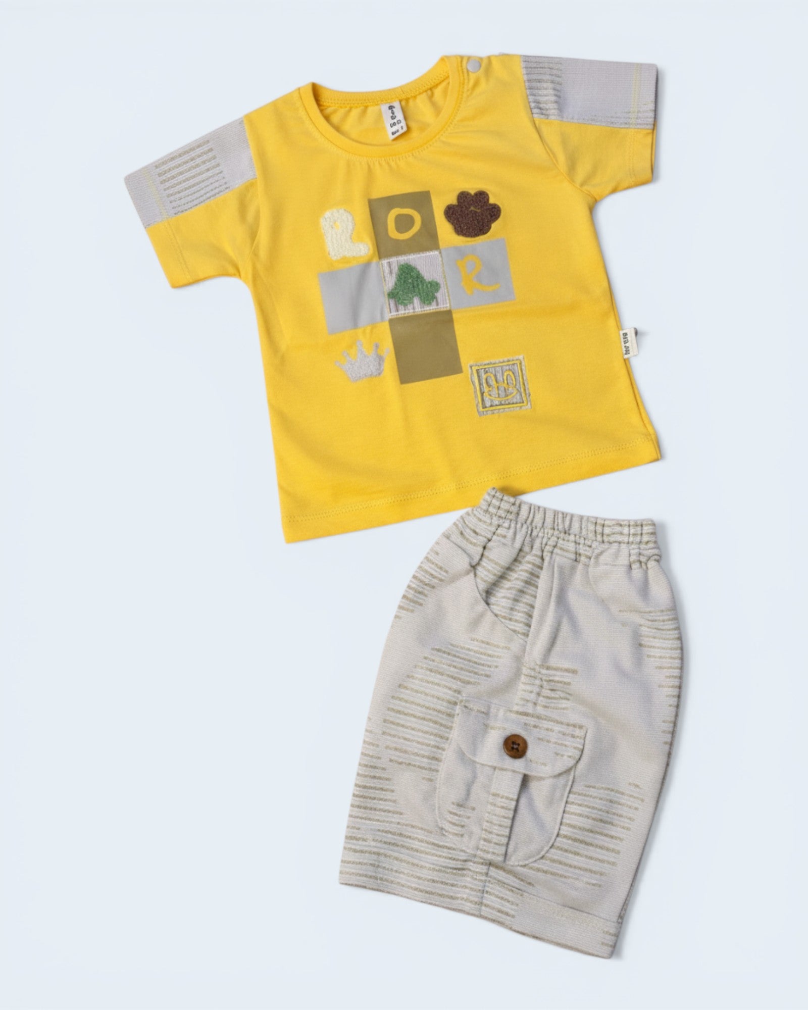 Little Roots baby boy yellow cotton graphic t-shirt with patchwork ROAR design and light grey cargo shorts with elastic waist.