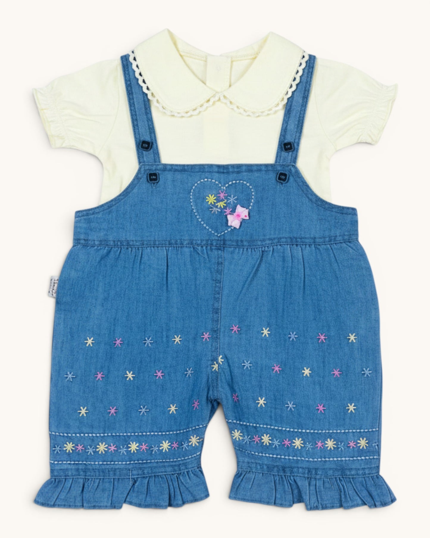 Little Roots baby girl's blue denim romper set with a cream puff sleeve top, featuring floral embroidery and ruffled hems.