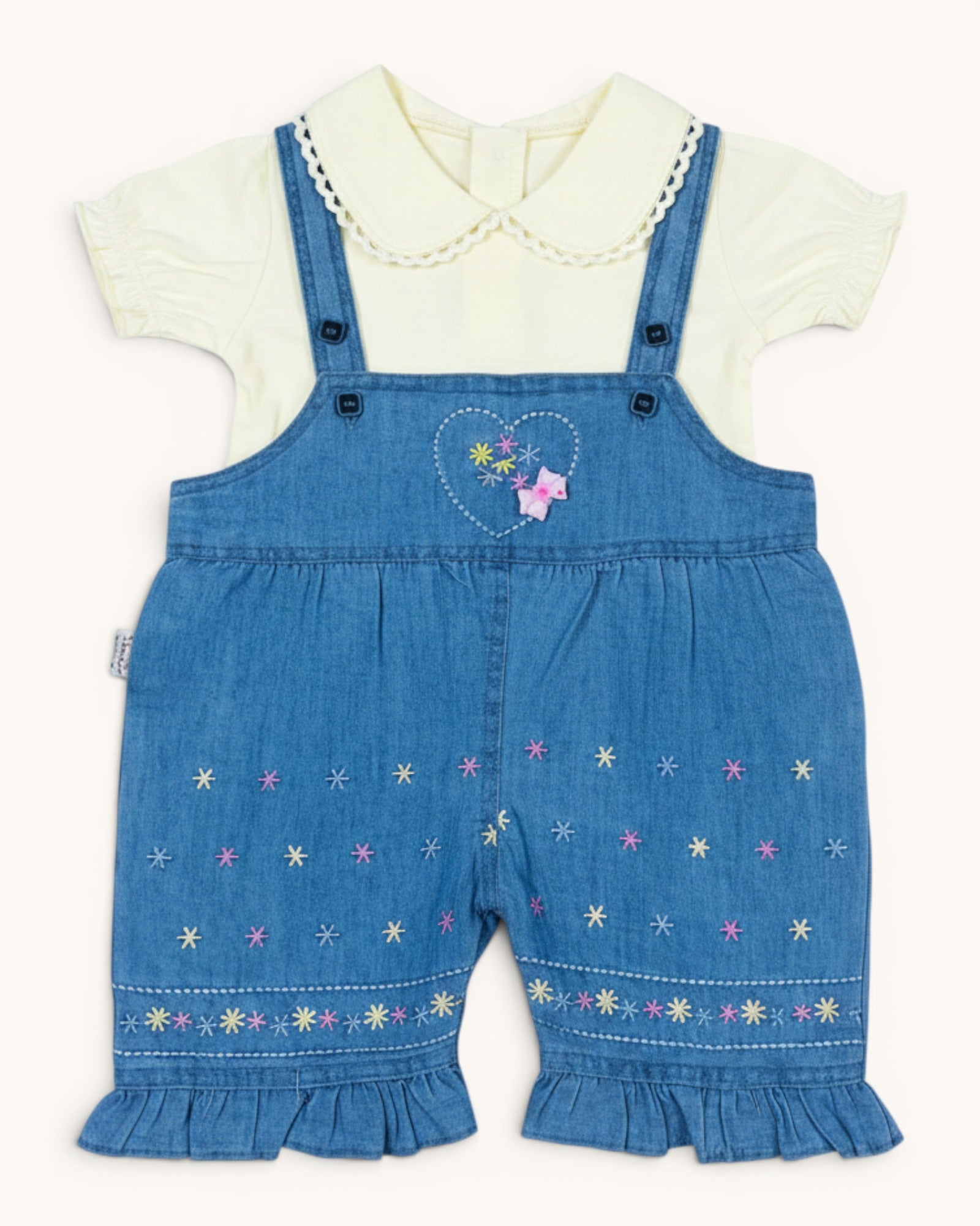 Little Roots baby girl's blue denim romper set with a cream puff sleeve top, featuring floral embroidery and ruffled hems.