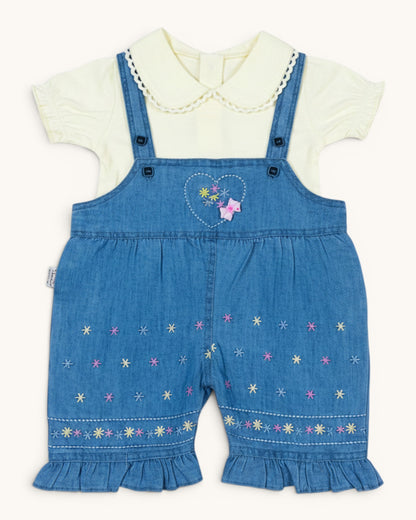 Little Roots baby girl's blue denim romper set with a cream puff sleeve top, featuring floral embroidery and ruffled hems.