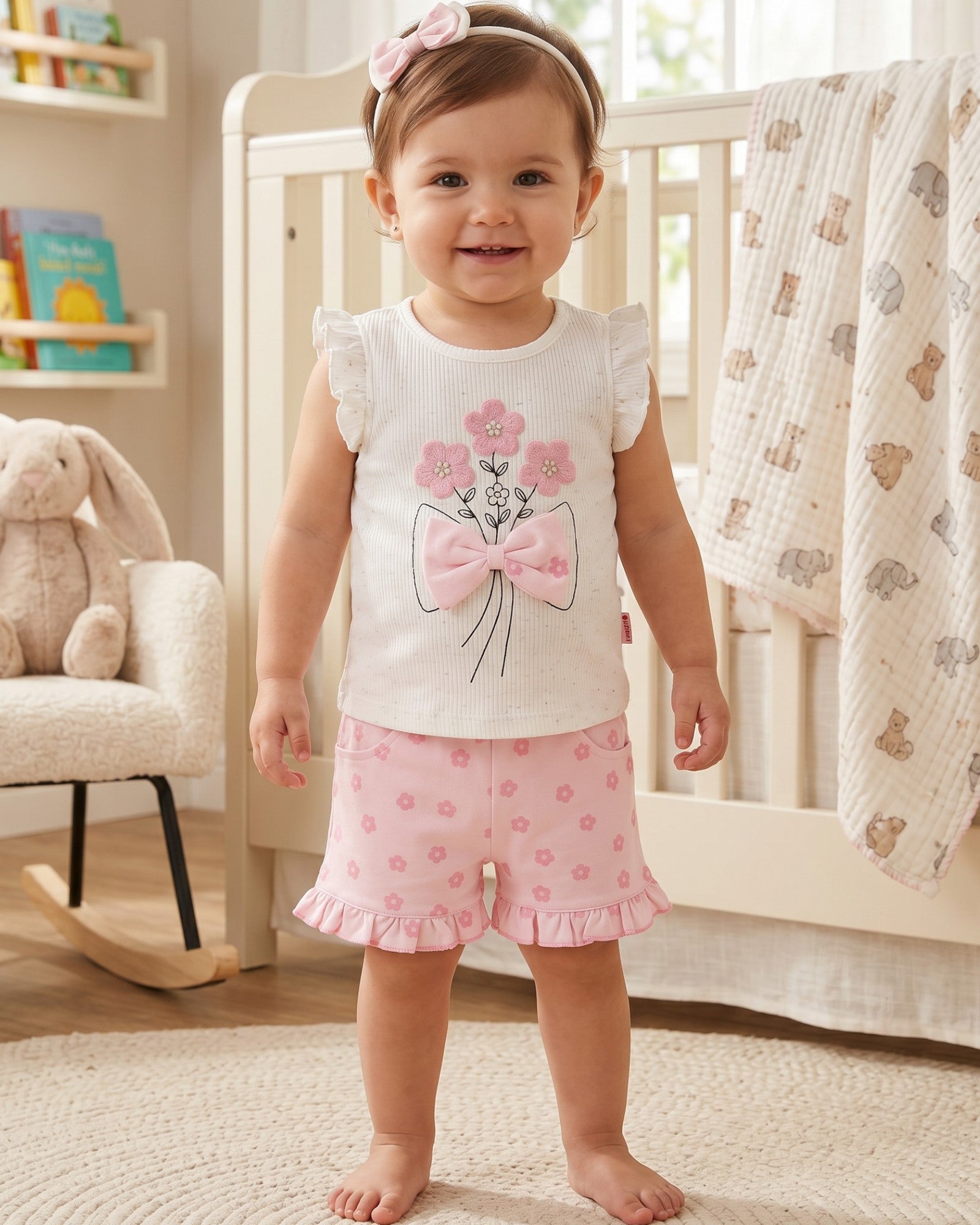 Little Roots baby girls' white floral embroidered top with pink bow and matching pink floral shorts and headband. Ruffled sleeves and hem.