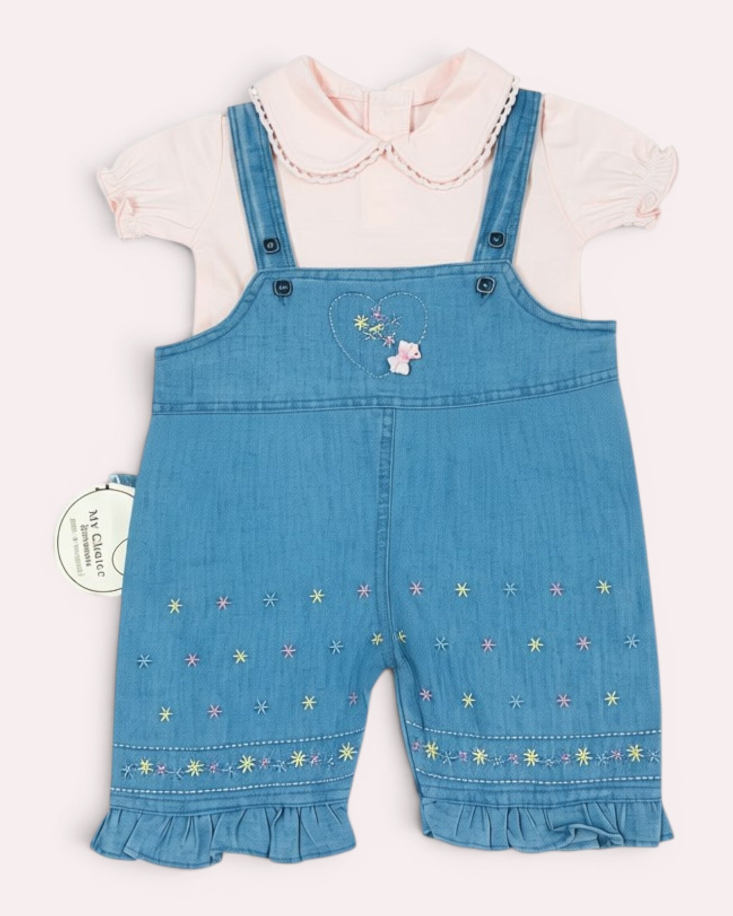 Little Roots baby girl pink puff sleeve top with a blue denim embroidered romper featuring floral details and ruffle hems.