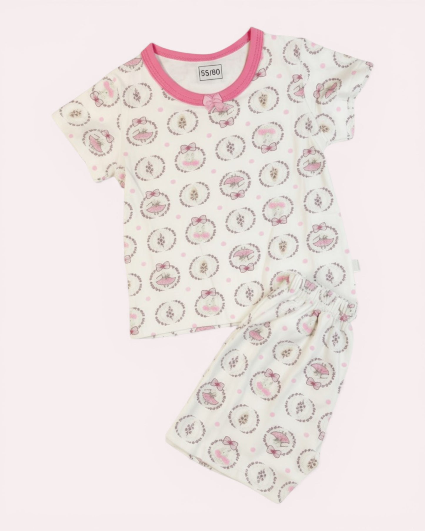 Little Roots baby girl's white cotton top and shorts set with pink print, bow detail, and elastic waist.