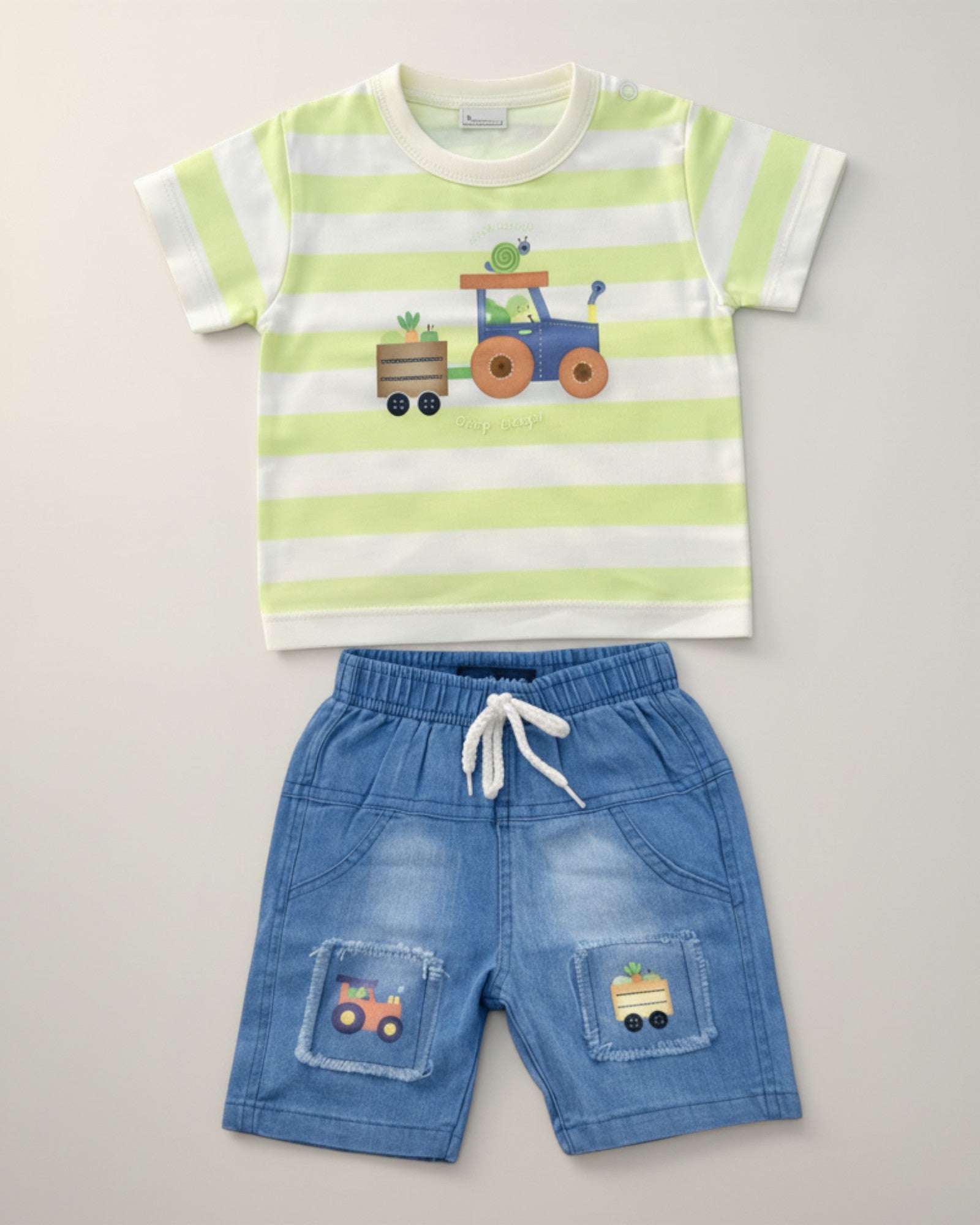 Little Roots Pakistan baby boy set: green & white striped tee with tractor print, blue denim shorts with tractor patches. Cotton blend.