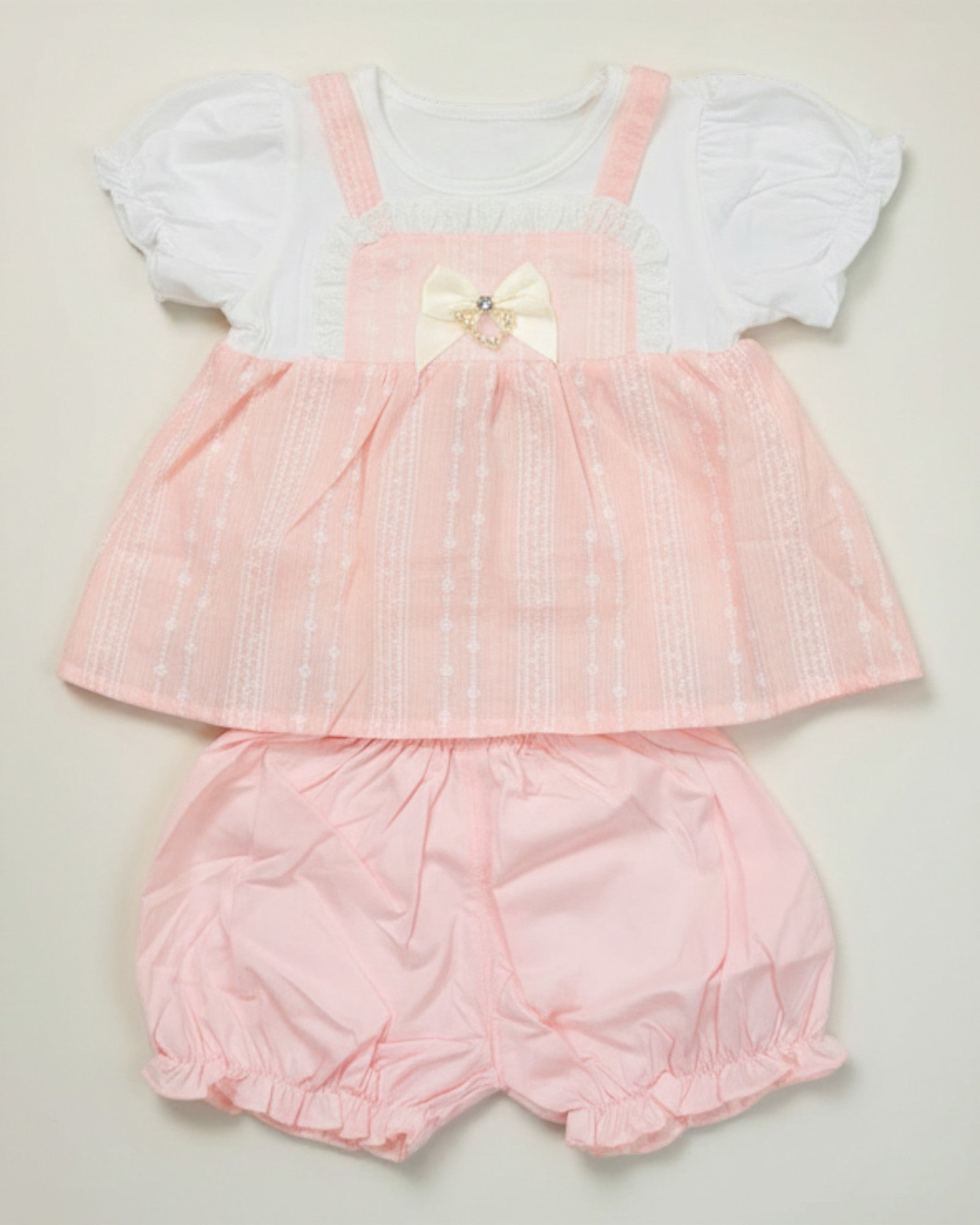 Little Roots baby girl peach textured frock with white puff sleeves and matching bloomers, featuring bow and pearl detail.