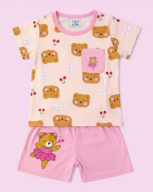 Little Roots baby girl peach cotton set with bear print top and pink shorts. Features a pocket with a bear detail.