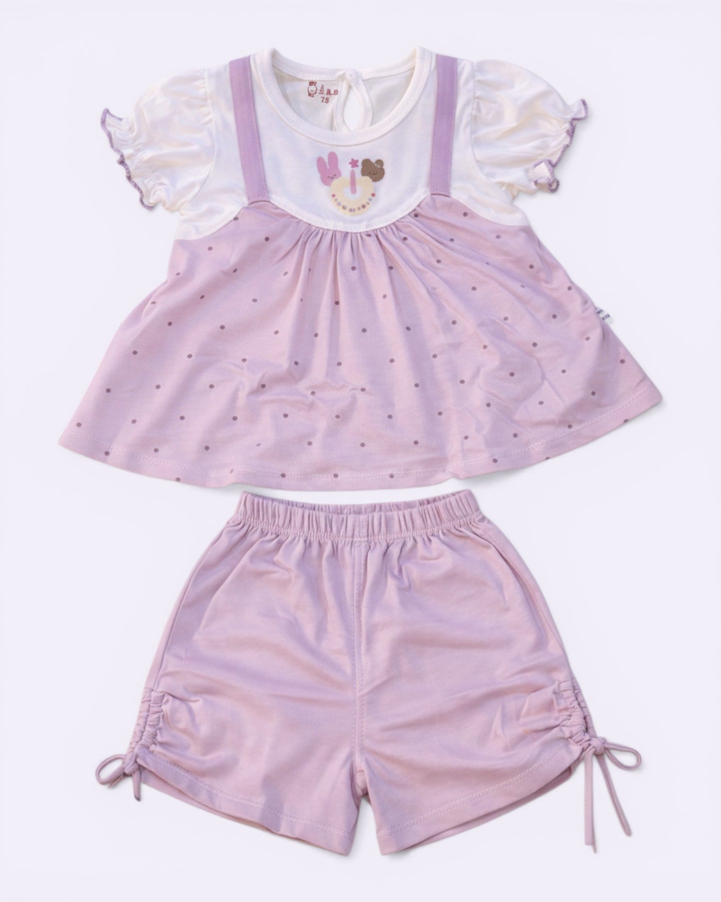 Little Roots Pakistan baby girl pink polka dot frock with cartoon print and matching shorts. Soft, breathable summer outfit.