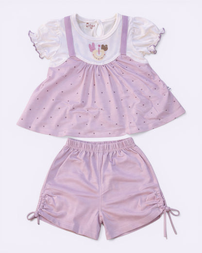 Little Roots Pakistan baby girl pink polka dot frock with cartoon print and matching shorts. Soft, breathable summer outfit.