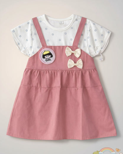 Little Roots baby girl pink pinafore dress with white floral print top, "Girl" patch, and double bow accents.