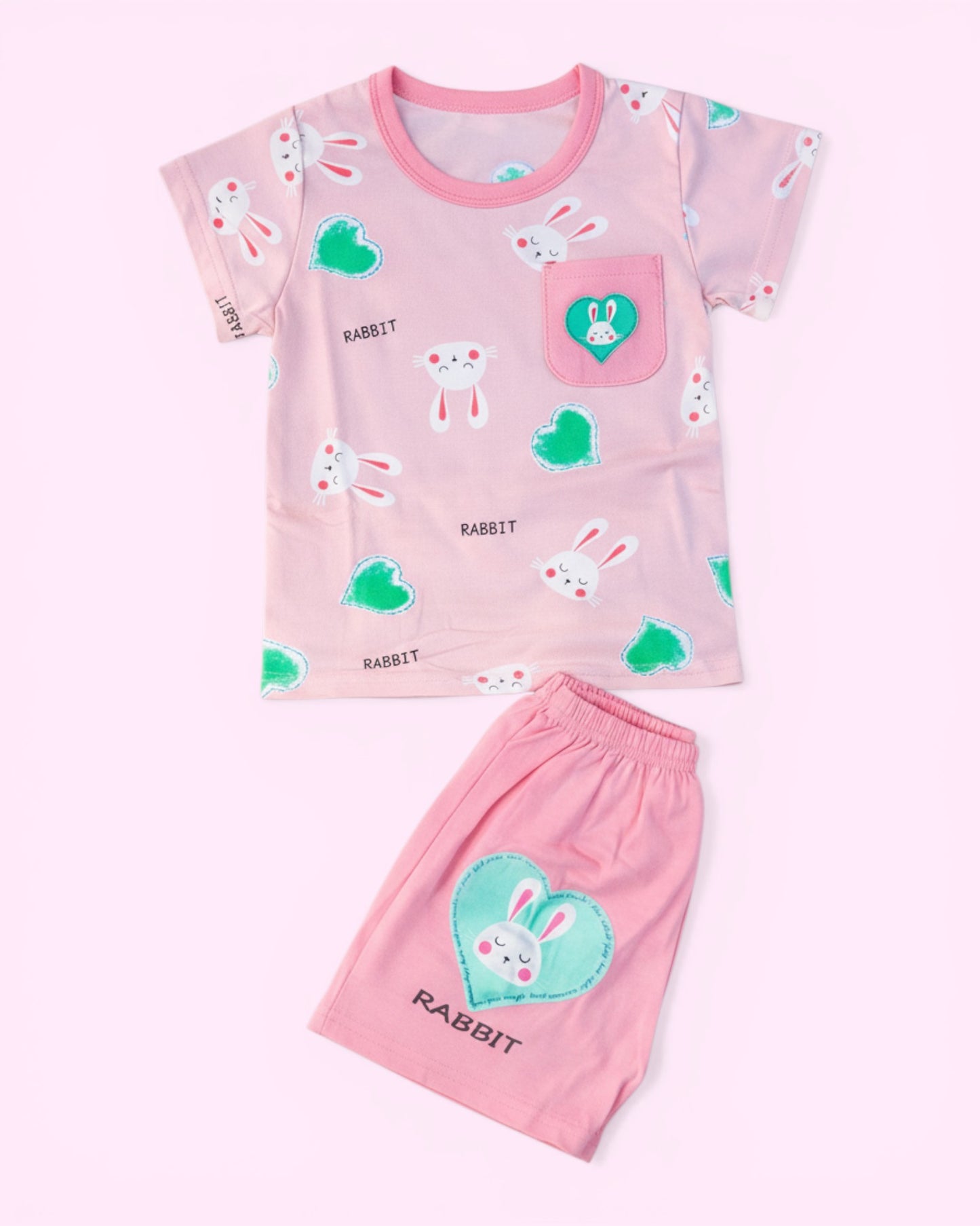 Little Roots baby girl pink cotton set with rabbit and heart print, featuring a pocket detail and elastic waist shorts.