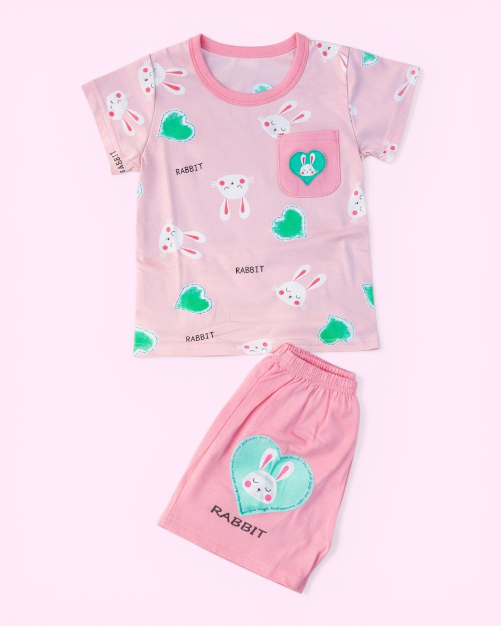 Little Roots baby girl pink cotton set with rabbit and heart print, featuring a pocket detail and elastic waist shorts.